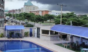 a swimming pool on the roof of a building at Grand Cubana Hotels-alcove Room in Jabi +17 photos