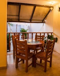 a dining room table and chairs with a glass top at Hb3 Double Room with private bathroom facing the sea in Cartagena de Indias +13 photos