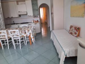 a kitchen with a table and chairs in a room at Villa Lesto Holiday Home - Ischia Apartment in Ischia +8 photos