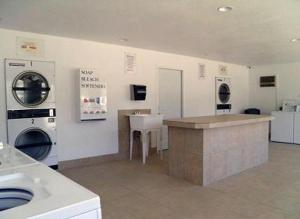 a laundry room with a sink and a washing machine at Death Valley Inn & RV Park in Beatty