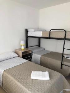 two beds in a room with two bunk beds at WaraKusi Country Houses - Ground floor - Off Road in Vaqueros