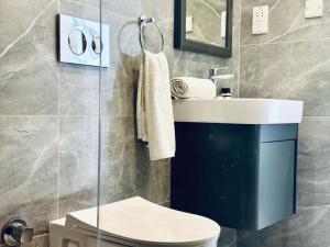 a bathroom with a toilet and a sink at B1-14 Crystal Bay Retreat - Pool View Apartment in Ayios Nikolaos