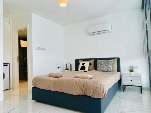 a bedroom with a large bed with pillows on it at B1-14 Crystal Bay Retreat - Pool View Apartment in Ayios Nikolaos