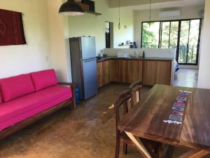 a living room with a couch and a table and a kitchen at Departamento Completo, Playa Paradisiaca, in Cuatunalco