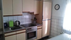 a kitchen with a refrigerator and a stove at Charming Langelsheim Apartment in Historic Fachwerkhaus in Langelsheim