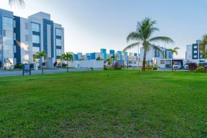 a park with palm trees in front of a city at 2 Bedrooms and Pool Acapulco Penthouse in Gallinero
