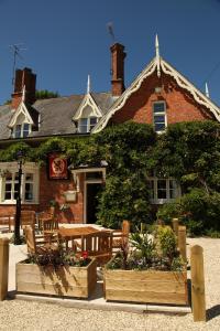 a restaurant with a table and chairs in front of a building at The Red Lion in Revesby