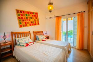 a bedroom with two beds and a window with a view at 4-bedroom villa with amazing views in Lapithos +56 photos