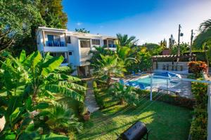 an aerial view of a house and a swimming pool at Fully Equipped 2br Apt-dt5mins To The Beach in Sosúa