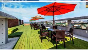 a row of tables and chairs with umbrellas on a roof at Galaxy Hotel in Jeju