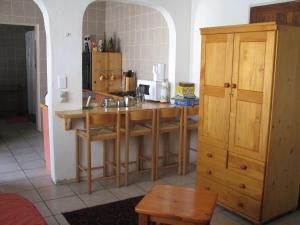 a kitchen with wooden tables and a counter top at Absolute Leisure Cottages in Machadodorp