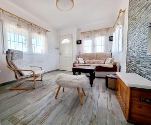 a living room with a couch and a chair at Charming Upper Bungalow with Terrace and Communal Pool in Torrevieja in Torrevieja