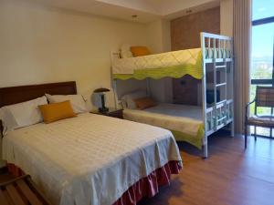 a bedroom with two beds and a bunk bed at Departamento Independencia in Tarija
