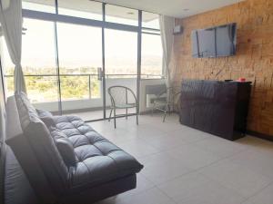 a living room with a couch and a flat screen tv at Departamento Independencia in Tarija