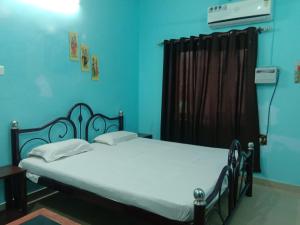a bedroom with a bed in a blue room at Janardan Homestay Lucknow in Lucknow