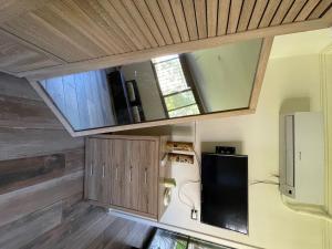 a small kitchen with a window and a refrigerator at Chalet in Batrouna Park resort, facing the pool, gazon,gym,GENERATOR IS INCLUDED in Al Ḩulwah