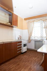 a kitchen with a stove and a window at Granit Hotel in Vladivostok