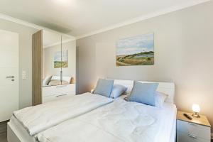 Postel nebo postele na pokoji v ubytování Relax Bungalow Strandperle