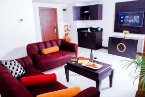 a living room with two chairs and a coffee table at Limewood Hotel Presidential Suite in Port Harcourt