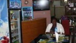 a woman sitting at a counter in a store at Bahamas Hotels International in Abuja +13 photos