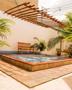 a pool in the middle of a patio with a bench at Hb4 Double Room with Private Bathroom and Balcony in Cartagena de Indias