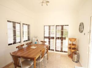 a dining room with a wooden table and chairs at Villa Tanyeli with Private Pool and Terrace in Lapithos