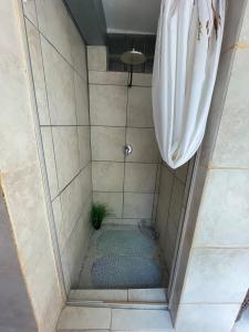 a shower with a shower curtain in a bathroom at Living In Camps Bay Summer in Cape Town +15 photos