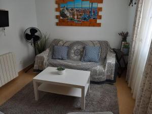 a living room with a couch and a table at Cozy Apartment Near The Beach in Barcelona