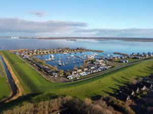 an aerial view of a marina with boats at 6pers Modern harbor house Jasmijn with fenced garden and lake view in Anjum