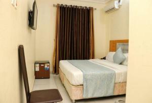 a hotel room with a bed and a window at Bayse One Premium Hotel - Standard Room with free Wifi in Ibadan