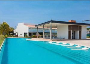 a large swimming pool in front of a building at New beautiful house in El Tigre, Golf Club, Punta Cala 205 in Nuevo Vallarta