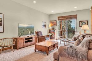 a living room with a couch and a tv at Sunny Daze Cabin Luxurious 4BDR with Stunning Views in Kings Beach