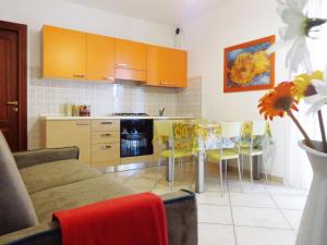 a kitchen with a couch and a table and chairs at Il Mare di Alida in Alghero