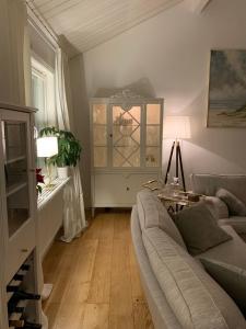 a living room with a couch and a table at Charming property with private pool in Märsta
