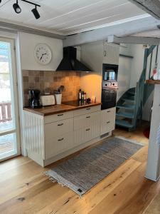 a kitchen with a counter and a stove top oven at Charming property with private pool in Märsta