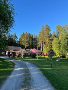 a dirt road in front of a house at Charming property with private pool in Märsta