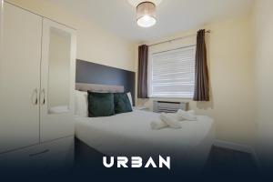 a bedroom with a white bed and a window at Perfect Contractor House 3 Bedroom Sleeps 7 in Peterborough