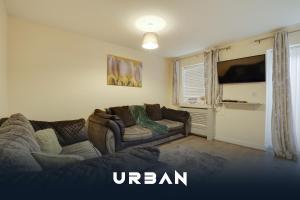 a living room with a couch and a tv at Perfect Contractor House 3 Bedroom Sleeps 7 in Peterborough