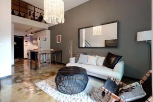 a living room with a white couch and a table at Seoul Loft Apartments - SLA 7 Night Minimum in Seoul