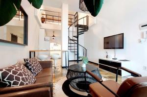 a living room with a couch and a table at Seoul Loft Apartments - SLA 7 Night Minimum in Seoul