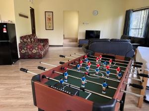 a room with a foosball table in the middle at Orchard Villa, Radiant Janda Baik in Bentong +17 photos