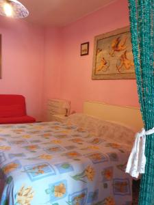 a bedroom with a bed with a flowered bedspread at Casa Di Collina Nelle Langhe Typical country house in Belvedere Langhe