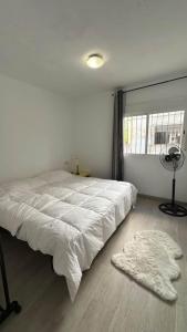 a white bedroom with a large bed and a window at Apartment Almazora II Rental Holidays Ref 036 in Almazora
