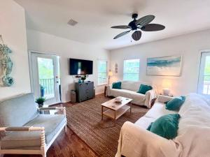 a living room with a couch and a ceiling fan at 4014 Rookery 3 Cottage with two Pools and Beach Amenities in Gulf Highlands