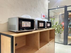 Tres microondas sobre un mostrador en una tienda en Rio Inn hotel в районе EXPO, en Astana 56 fotos más
