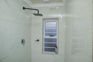 a bathroom with a shower with a window at One Bedroom apartment A3 in Cape Town +31 photos