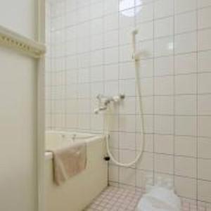 a bathroom with a shower with a toilet in it at City Heights Shinosaka 703 シティハイツ新大阪 703 in Osaka