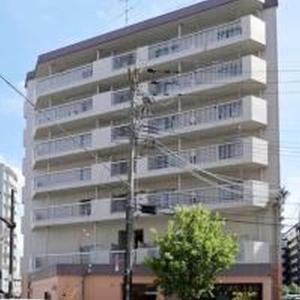 a tall white building with a tree in front of it at City Heights Shinosaka 703 シティハイツ新大阪 703 in Osaka