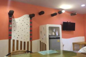 a room with a climbing wall and a table at Sa-Bai-Buri in Ban Nong Muang