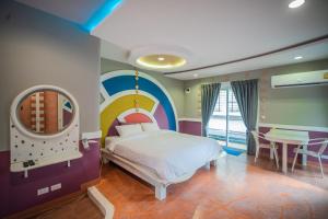 a bedroom with a bed with a rainbow wall at Sa-Bai-Buri in Ban Nong Muang